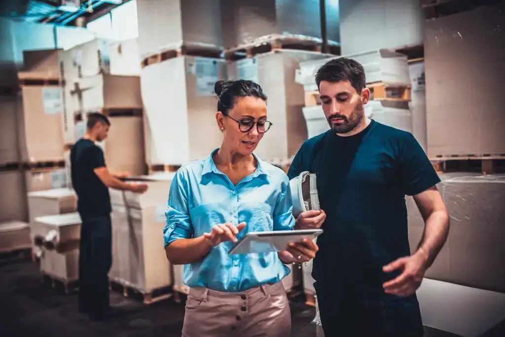 Warehouse supervisor showing a report to a manager