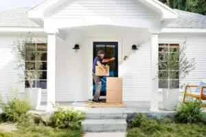 Delivery man knocking on the front door of a home.